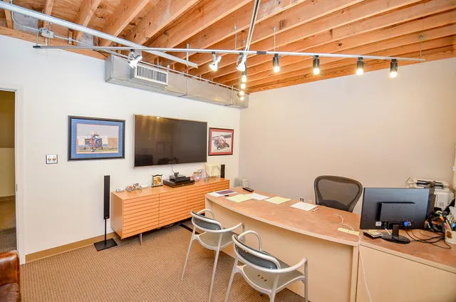 a bedroom with a bed and a chair