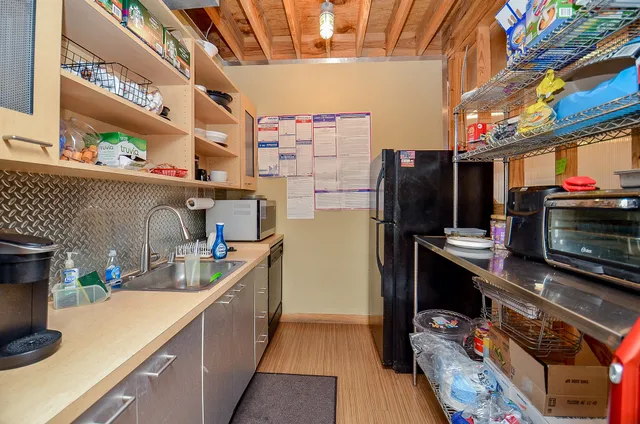 a kitchen with stainless steel appliances a stove a refrigerator a sink and a counter