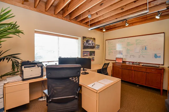 a living room with furniture a flat screen tv and a floor to ceiling window