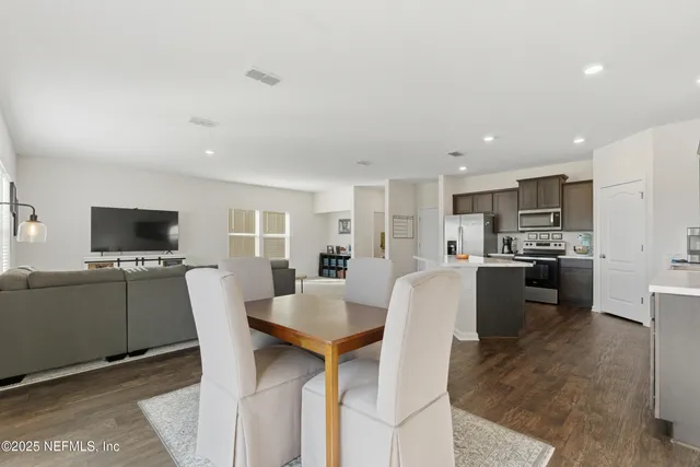 a view of kitchen with cabinets table and chairs