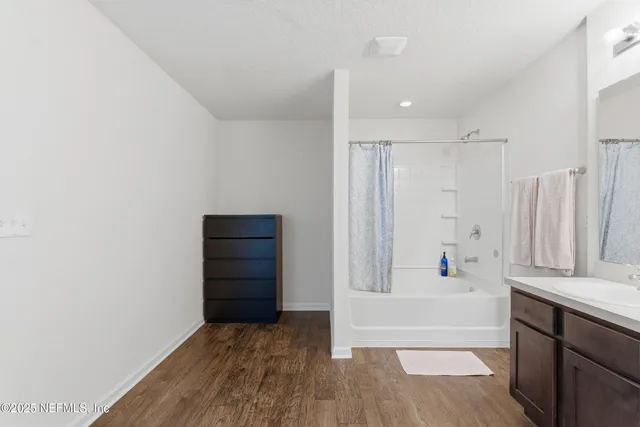 a bathroom with a sink mirror and toilet