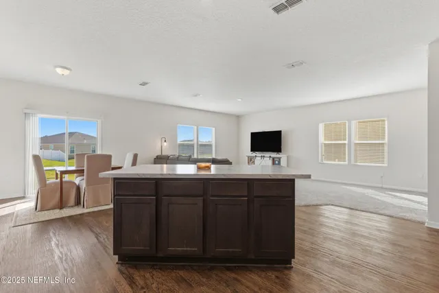 a view of a white house with a yard