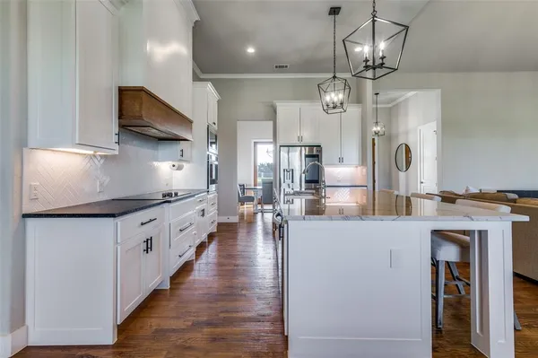a view of living room kitchen island and dining table