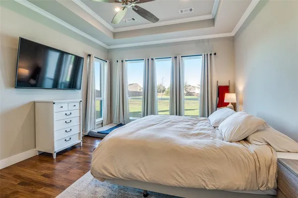 a bedroom with a bed and a large window