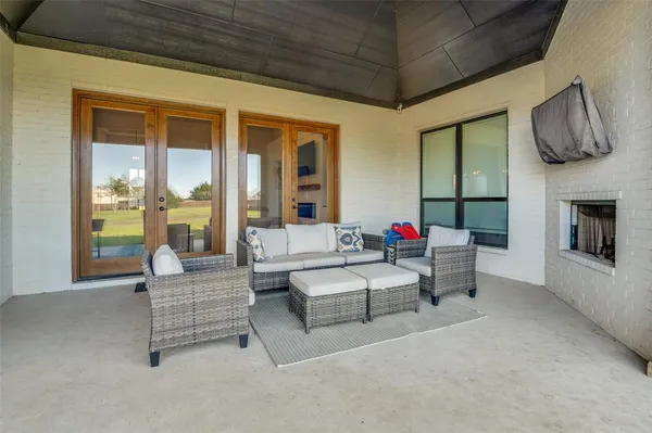 a living room with furniture ceiling fan and a rug