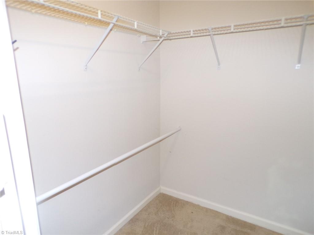 5005 Bass Chapel Road, Unit 1C Greensboro, NC 27455 - Photo 15 of 34 Primary walk-in closet.