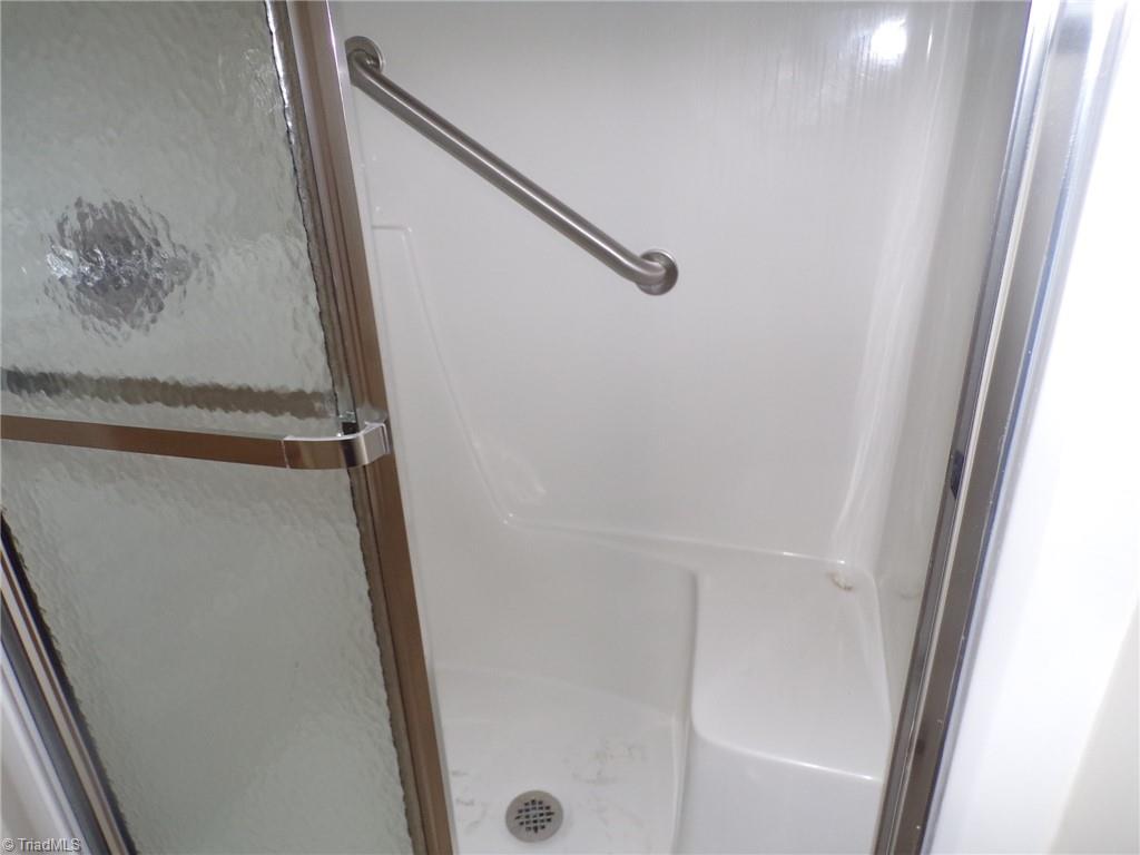 5005 Bass Chapel Road, Unit 1C Greensboro, NC 27455 - Photo 17 of 34 Handicap rod in primary shower.