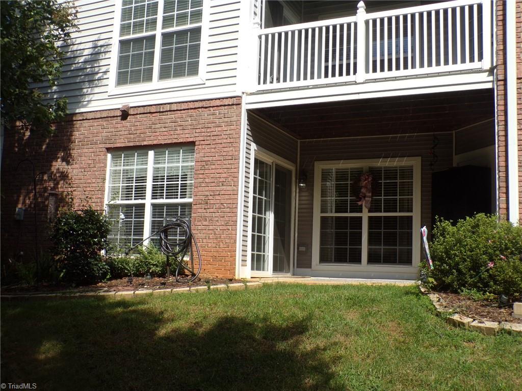 5005 Bass Chapel Road, Unit 1C Greensboro, NC 27455 - Photo 22 of 34 Back view of the covered porch and yard.