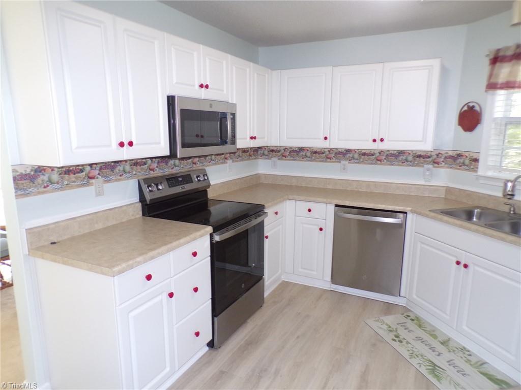 5005 Bass Chapel Road, Unit 1C Greensboro, NC 27455 - Photo 9 of 34 Microwave, slide-in range, dishwasher.