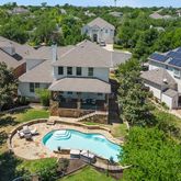 an aerial view of a house with swimming pool patio and outdoor seating