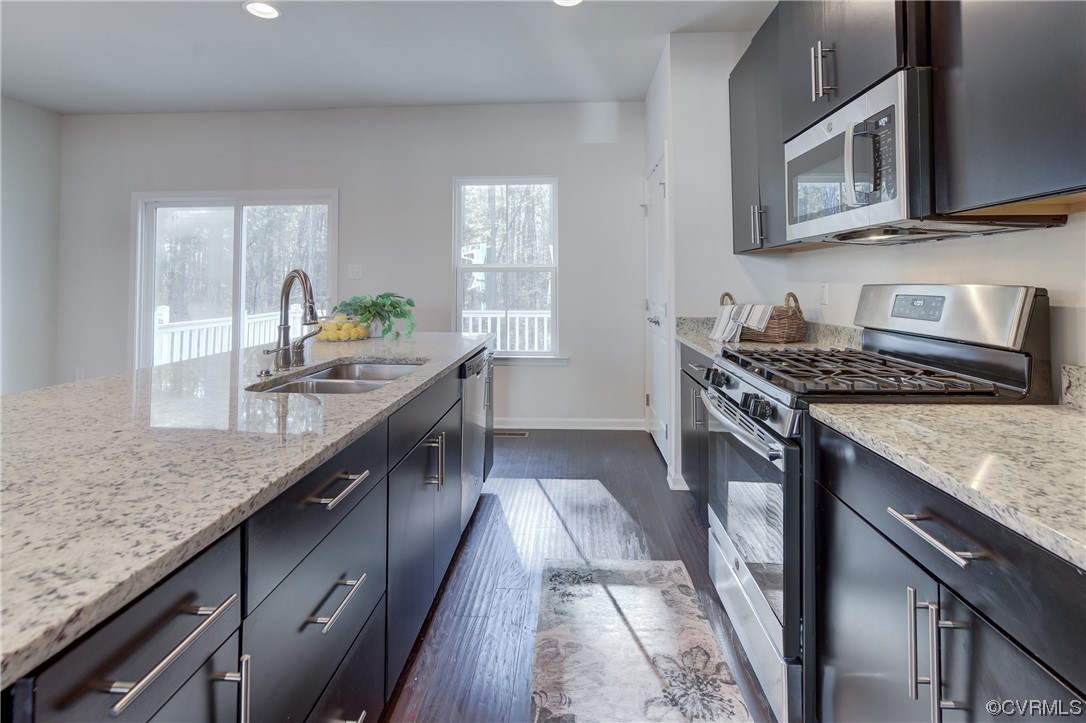 429 Crofton Village Terrace Midlothian, VA 23114 - Photo 11 of 35 a kitchen with stainless steel appliances granite countertop a stove a sink and a microwave