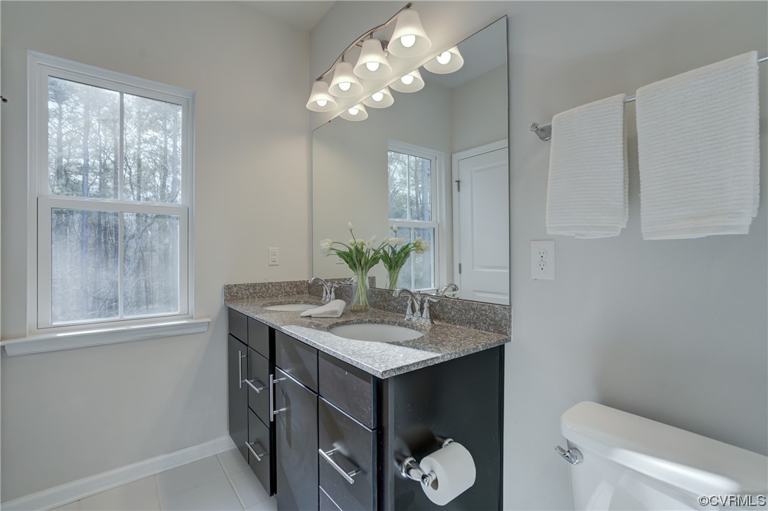 429 Crofton Village Terrace Midlothian, VA 23114 - Photo 21 of 35 a bathroom with a granite countertop sink a toilet and a mirror