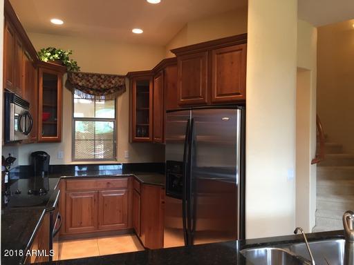 Undisclosed Address Gold Canyon, AZ 85118 - Photo 13 of 45 a kitchen with granite countertop a refrigerator and a sink