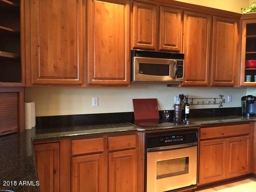 Undisclosed Address Gold Canyon, AZ 85118 - Photo 14 of 45 a kitchen with granite countertop a stove top oven cabinetry a sink and dishwasher
