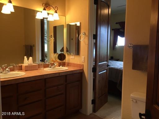 Undisclosed Address Gold Canyon, AZ 85118 - Photo 15 of 45 a bathroom with a double vanity sink and a mirror
