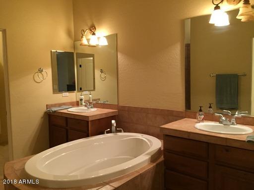 Undisclosed Address Gold Canyon, AZ 85118 - Photo 28 of 45 a bathroom with a sink and a mirror