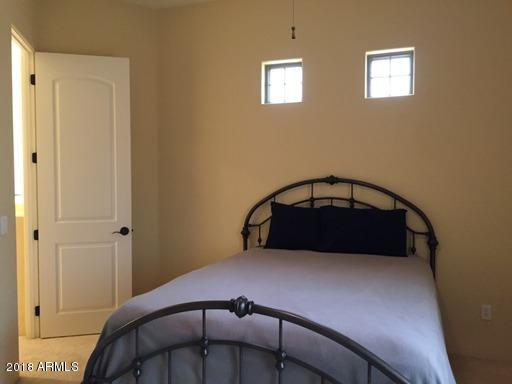 Undisclosed Address Gold Canyon, AZ 85118 - Photo 30 of 45 a bedroom with a bed and a window