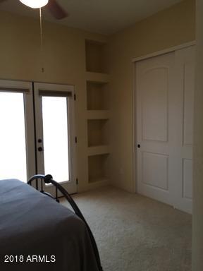 Undisclosed Address Gold Canyon, AZ 85118 - Photo 31 of 45 a bedroom with a bed and a chandelier