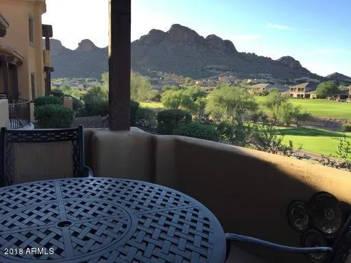 an aerial view of green landscape with trees houses and mountain view