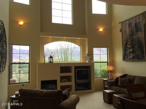 Undisclosed Address Gold Canyon, AZ 85118 - Photo 6 of 45 a living room with furniture a flat screen tv and a fireplace