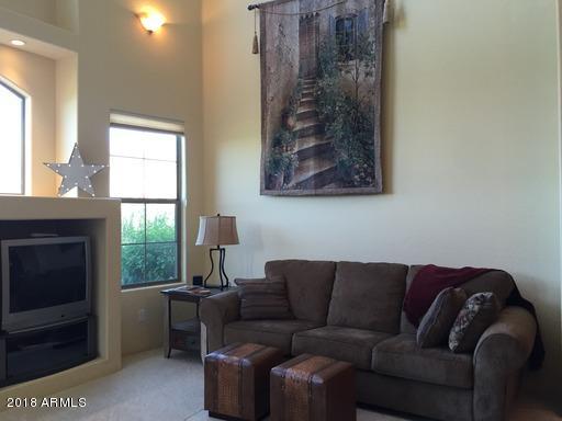 Undisclosed Address Gold Canyon, AZ 85118 - Photo 8 of 45 a living room with furniture a window and a fireplace