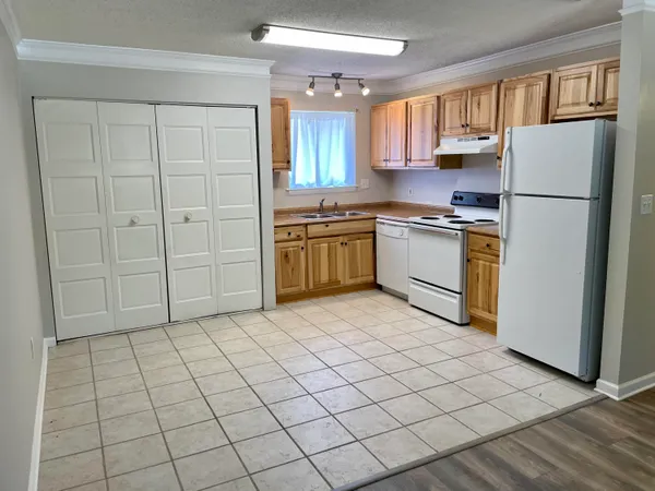 a kitchen with a refrigerator sink and cabinets
