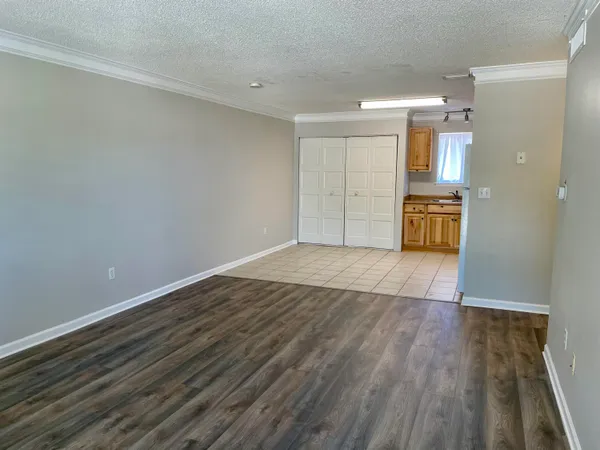 a view of a kitchen with wooden floor