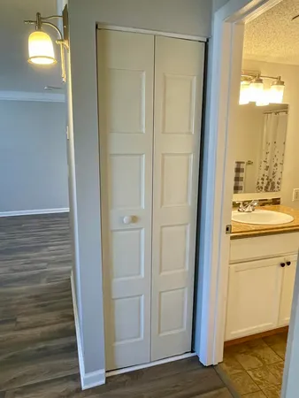 a view of walk in closet with hardwood floor