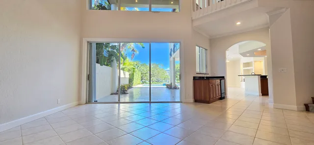 a view of a hallway with wooden floor and a living room