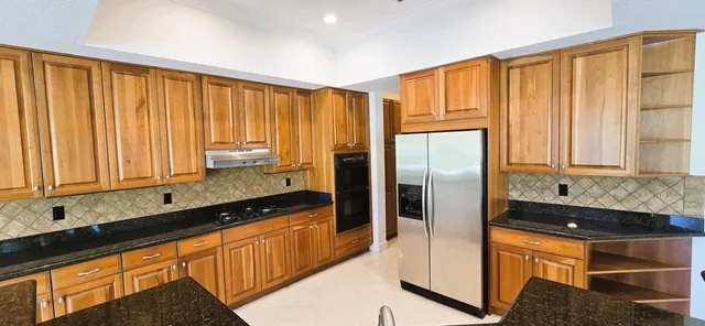 a kitchen with a sink and a large window