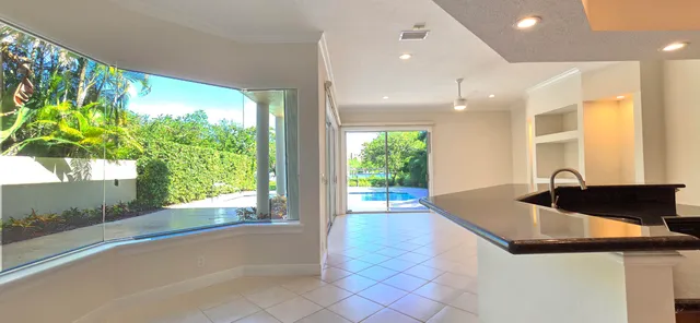 a view of an empty room with a fireplace and a window