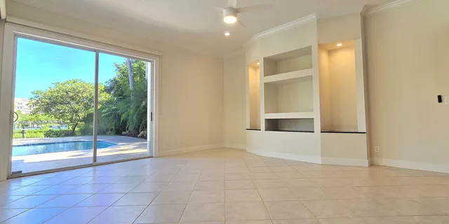 a room with a large window and bed