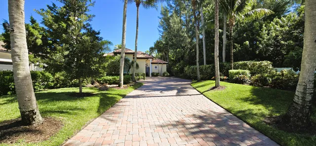 an aerial view of a house with a yard table and chairs