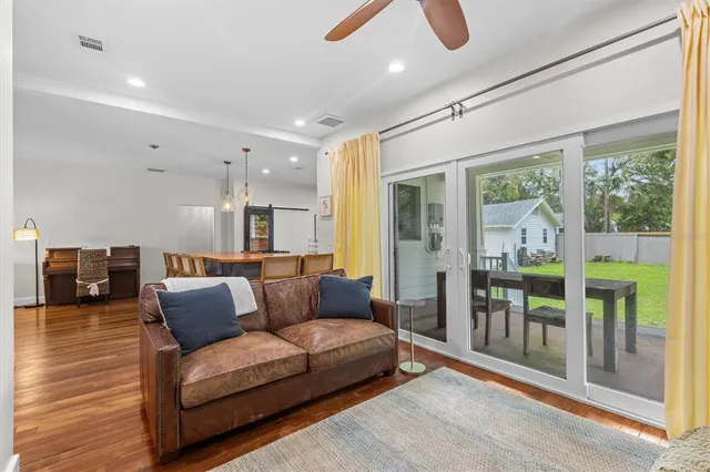 a living room with furniture and a floor to ceiling window