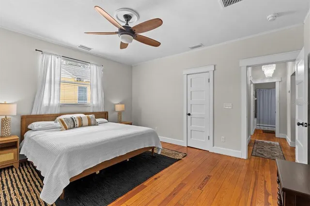 a bedroom with a bed and a chandelier