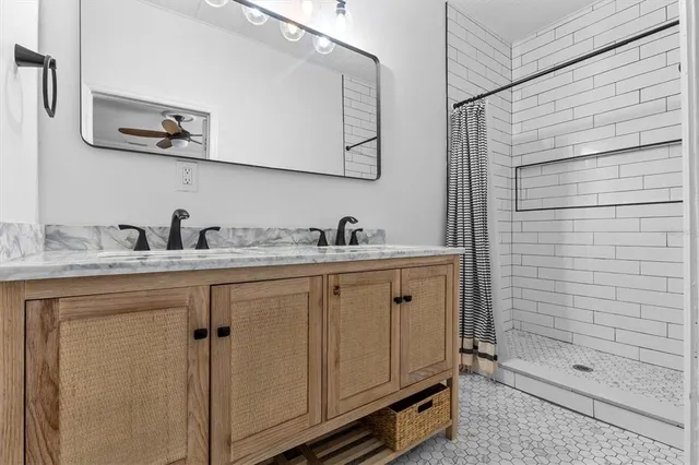a bathroom with a shower sink and mirror