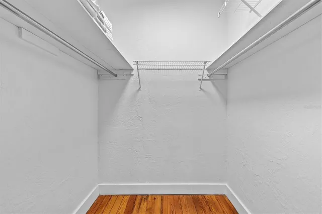 a view of walk in closet with empty racks