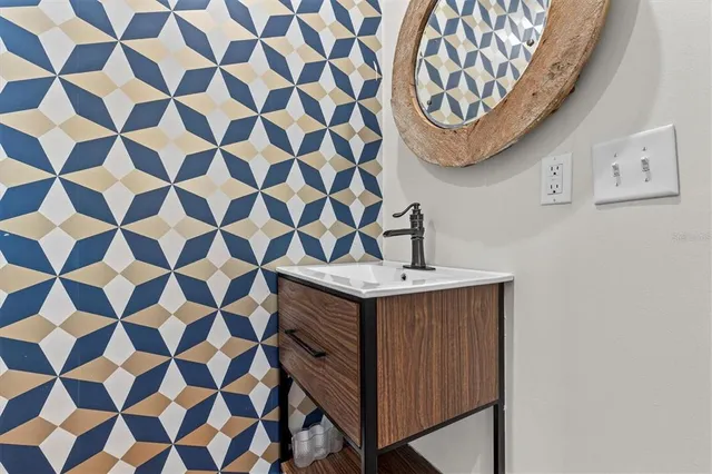 a bathroom with a sink a vanity and a shower curtain