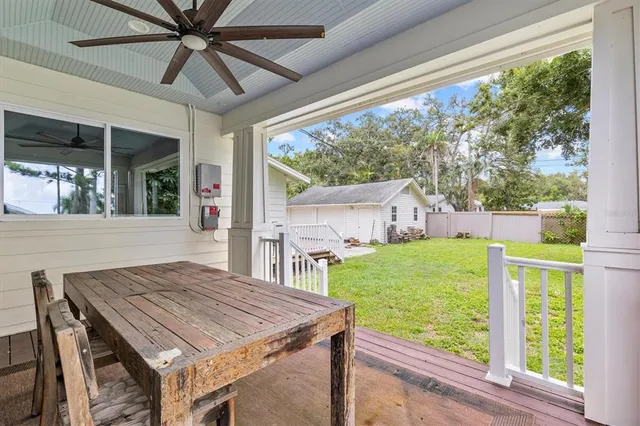 a view of a porch with furniture and a yard