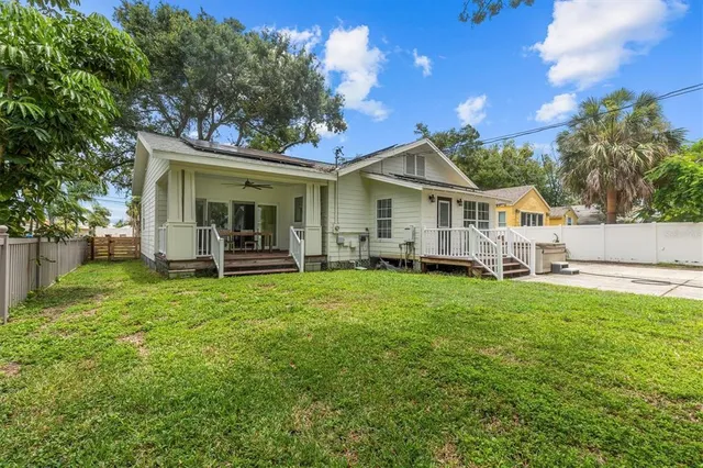 a view of a house with backyard and porch