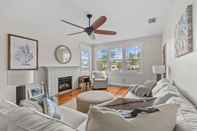 a living room with furniture a window and a fireplace