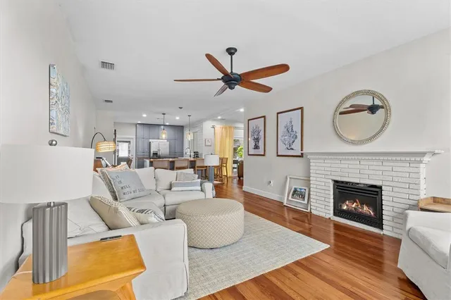 a living room with furniture a fireplace and a wall painting