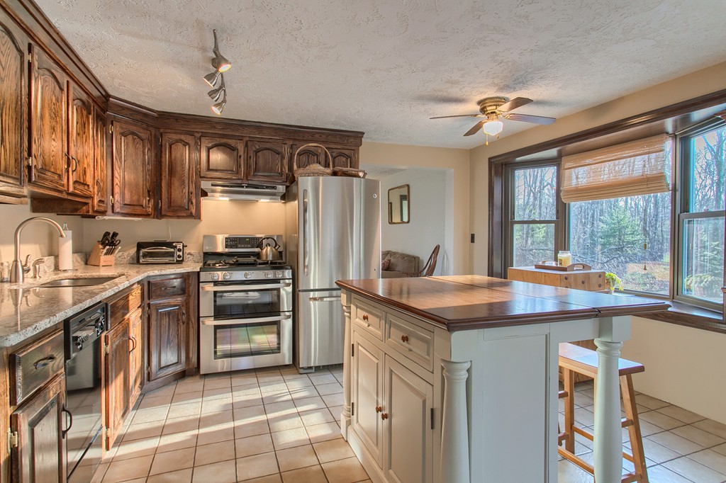 61 Griggs Road Sutton, MA 01590 - Photo 3 of 30 a kitchen with stainless steel appliances granite countertop a stove and a refrigerator
