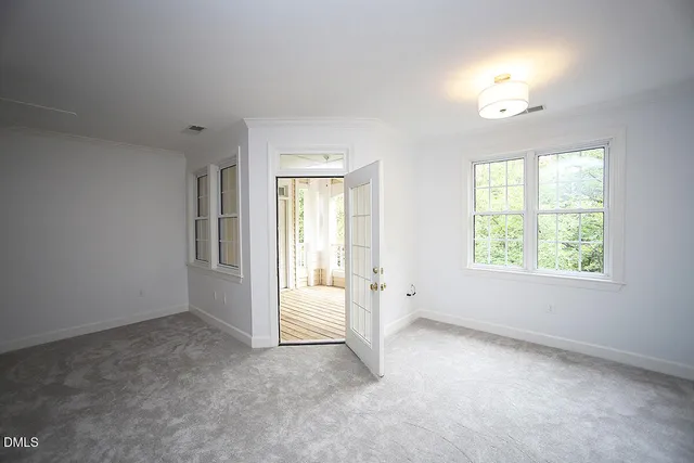 a view of walk in closet with empty racks