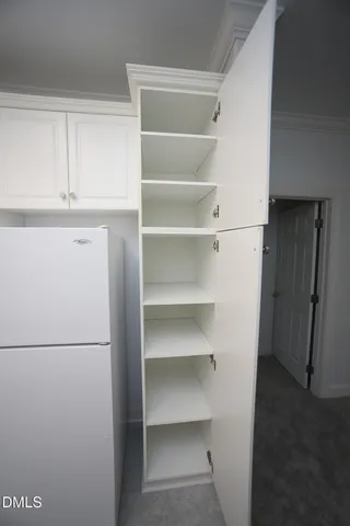 an empty room with windows and ceiling fan