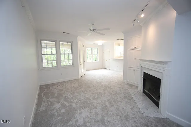 an empty room with windows and closet