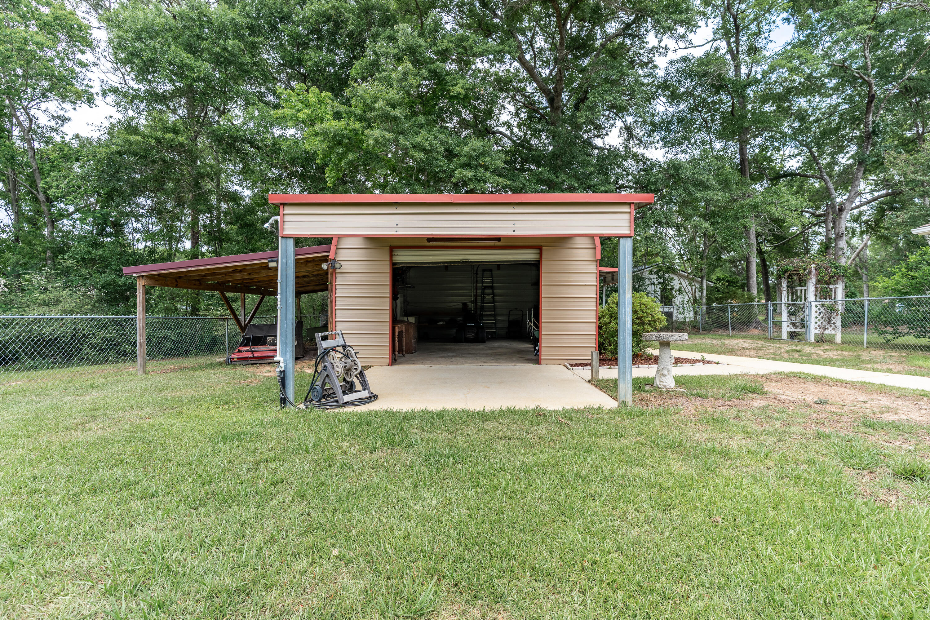 6100 Buckward Road Baker, FL 32531 - Photo 17 of 55 a view of an house with backyard space and a tree