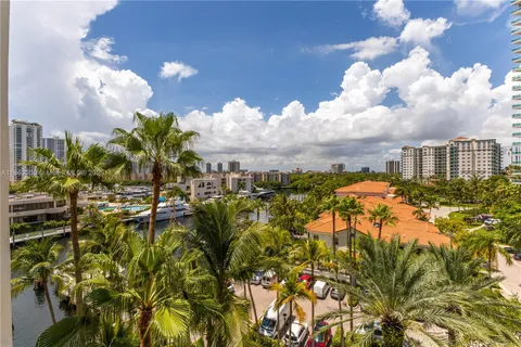 a bedroom with two beds and a flat screen tv