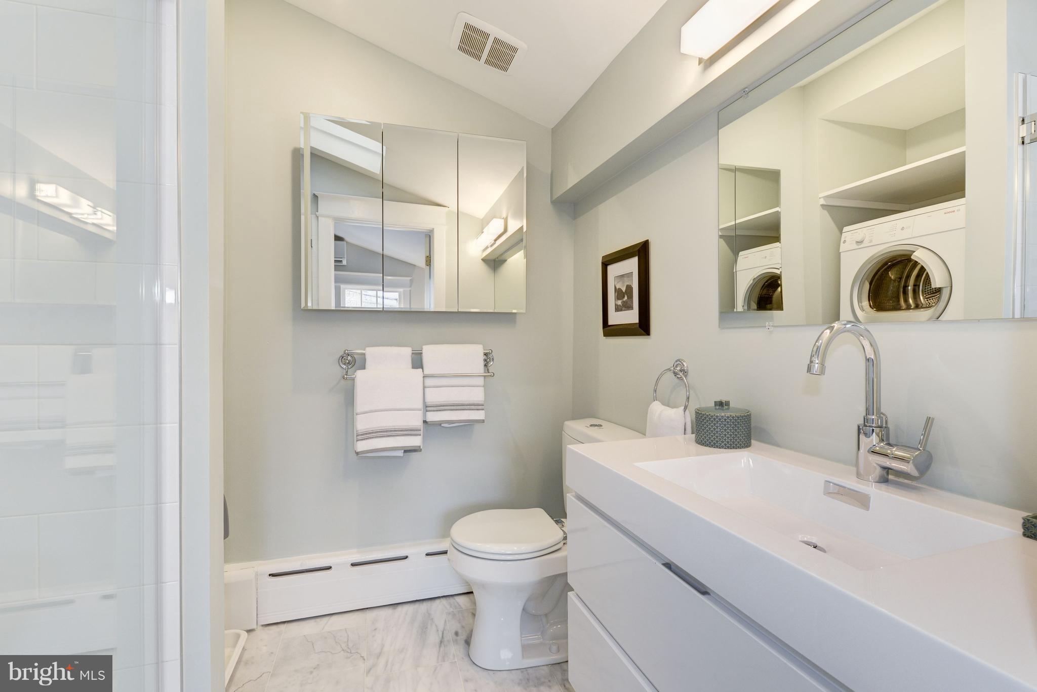 3601 T Street Northwest Washington, DC 20007 - Photo 12 of 20 a bathroom with a toilet a sink and mirror