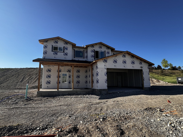 513 East Upper Cyn Road Smithfield, UT 84335 - Photo 3 of 25 Newly constructed residence featuring a two-car garage, covered porch, multiple windows, and a partially finished exterior
